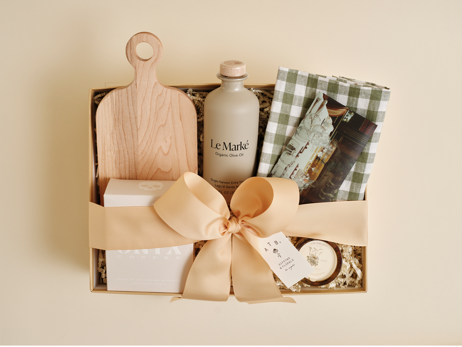 Luxury housewarming gift box with candle and kitchen essentials