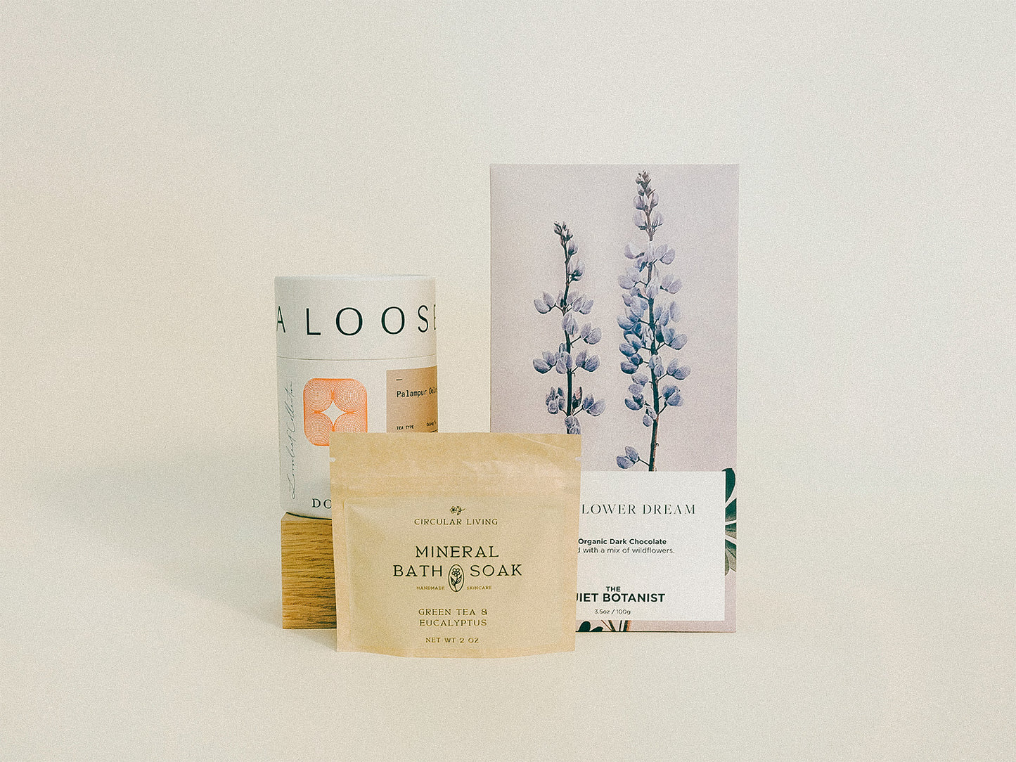 Luxury gift bundle containing loose leaf tea, gourmet chocolate, and bath soak. 