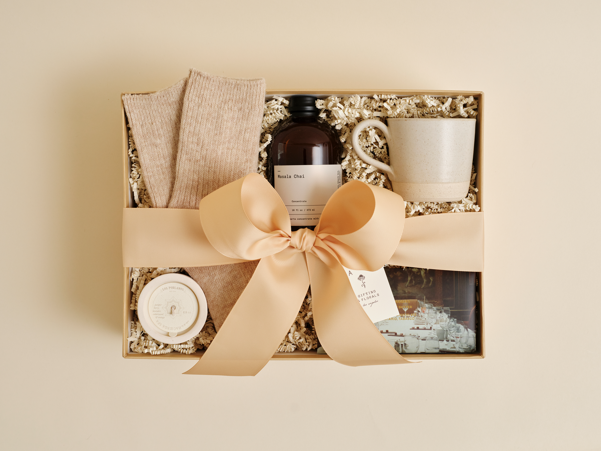 Luxury wellness gift box with candle, tea, and cozy socks
