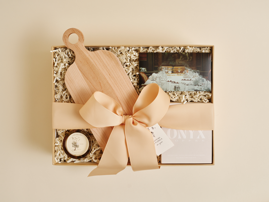 Luxury housewarming gift box with candle, coffee, and chocolate