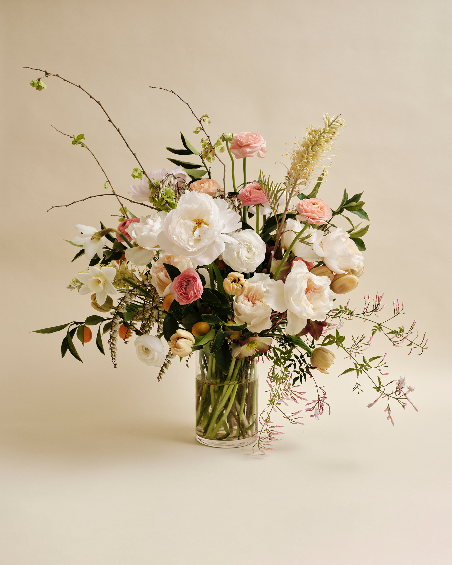 Luxe flower arrangement with seasonal blooms in glass vase 