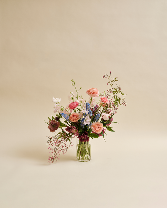 Petite seasonal flower arrangement with garden-style blooms in glass vase