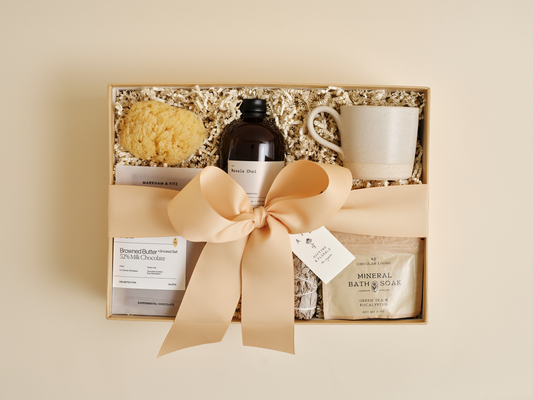 Luxury wellness gift box with tea, bath soak, and chocolate