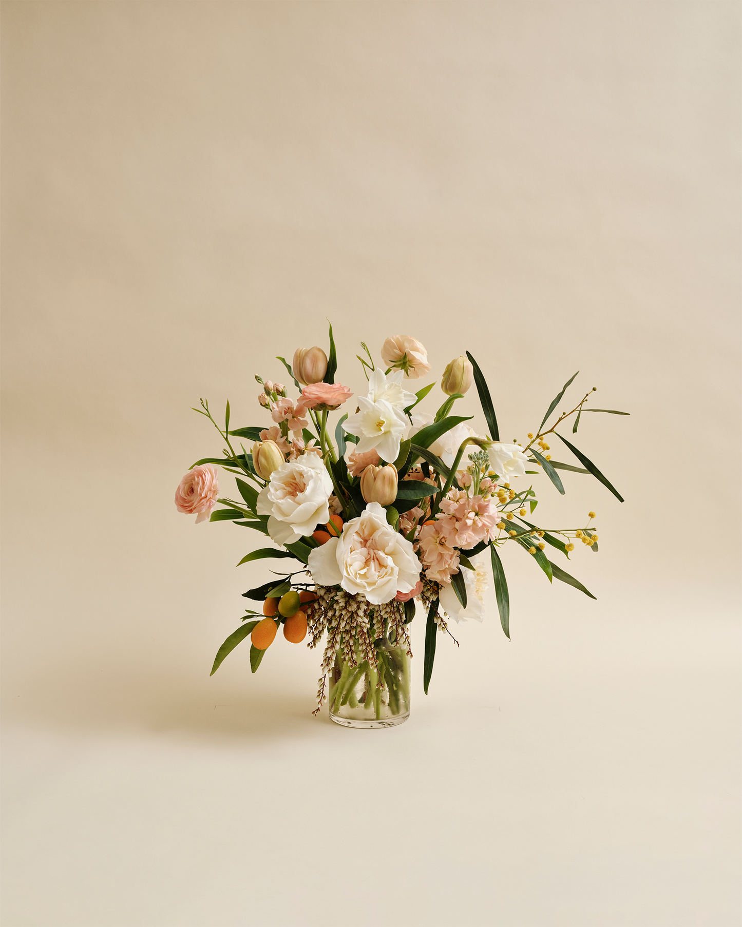 Signature seasonal flower arrangement with garden-style blooms in glass vase