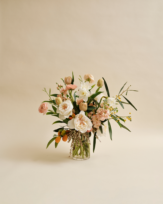 Signature seasonal flower arrangement with garden-style blooms in glass vase