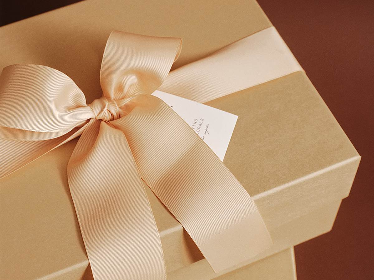 Ribbon-tied kraft custom gift box with All The Best tag